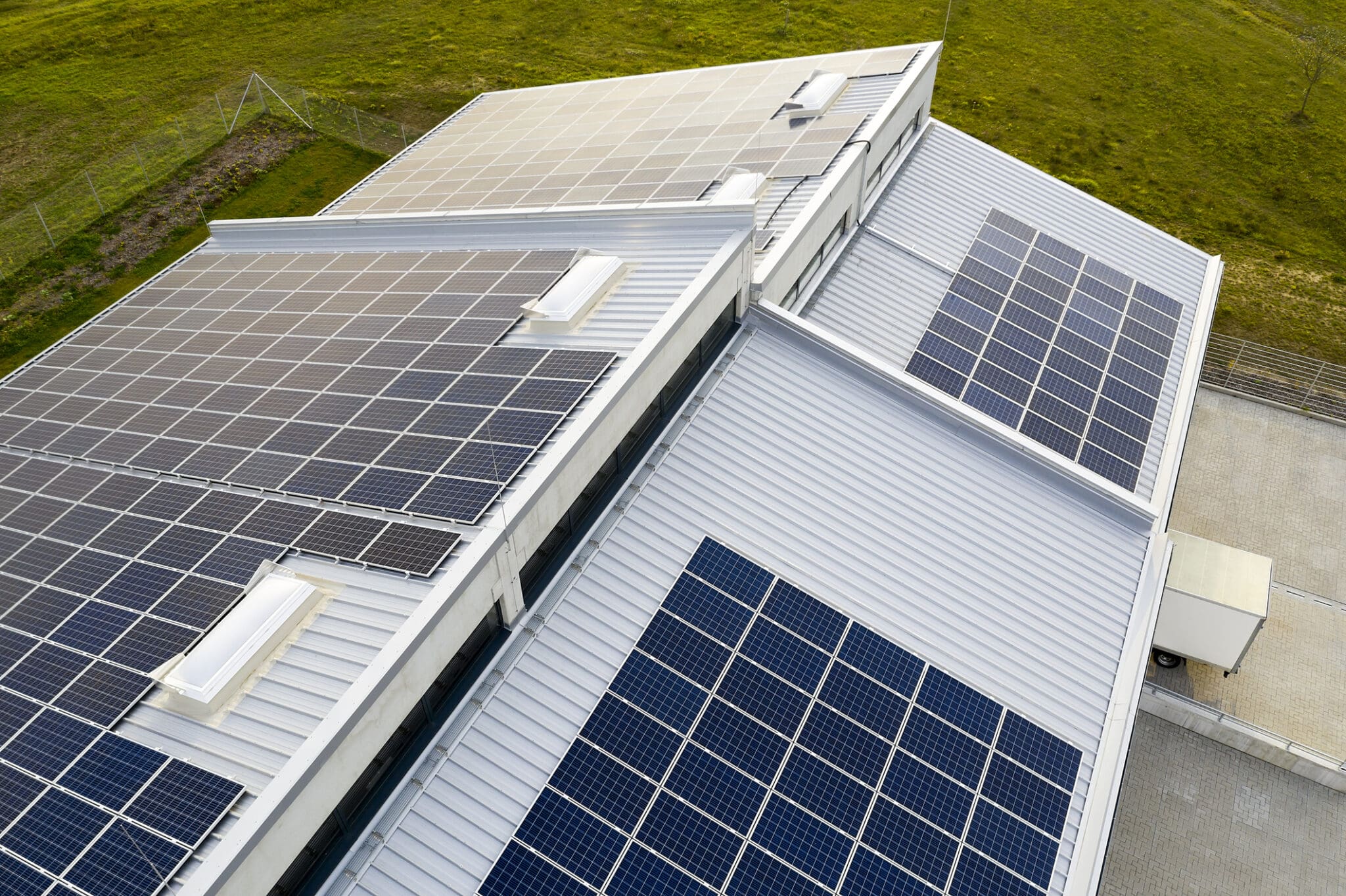 Solar panel photovoltaic installation on a roof of factory, alternative electricity source, sustainable resources concept.