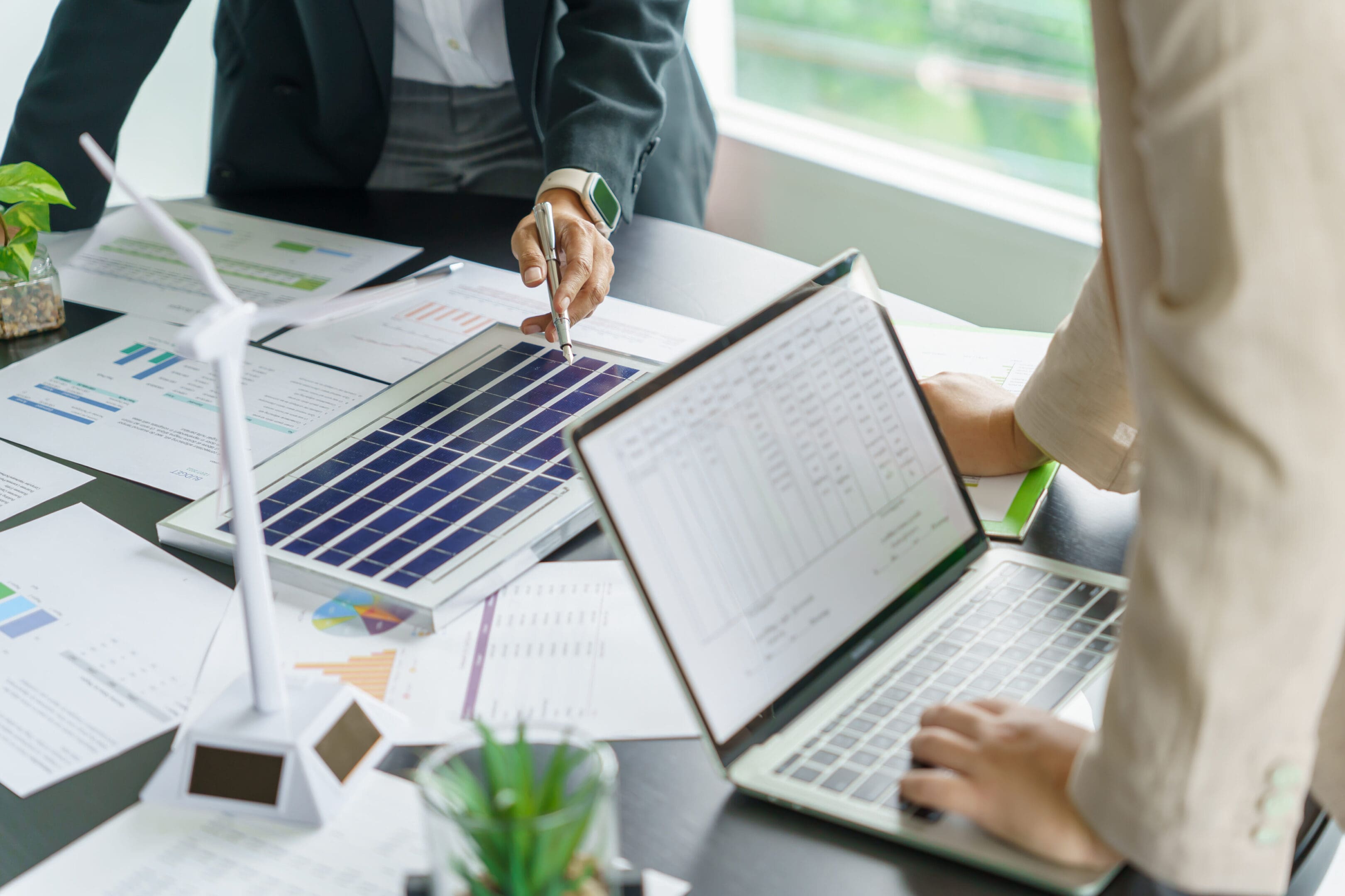 Solar panels green energy Business people working in green eco friendly office business meetingÂ creative ideas for business eco friendly professional teaching corporate people sustainable electricity project business.