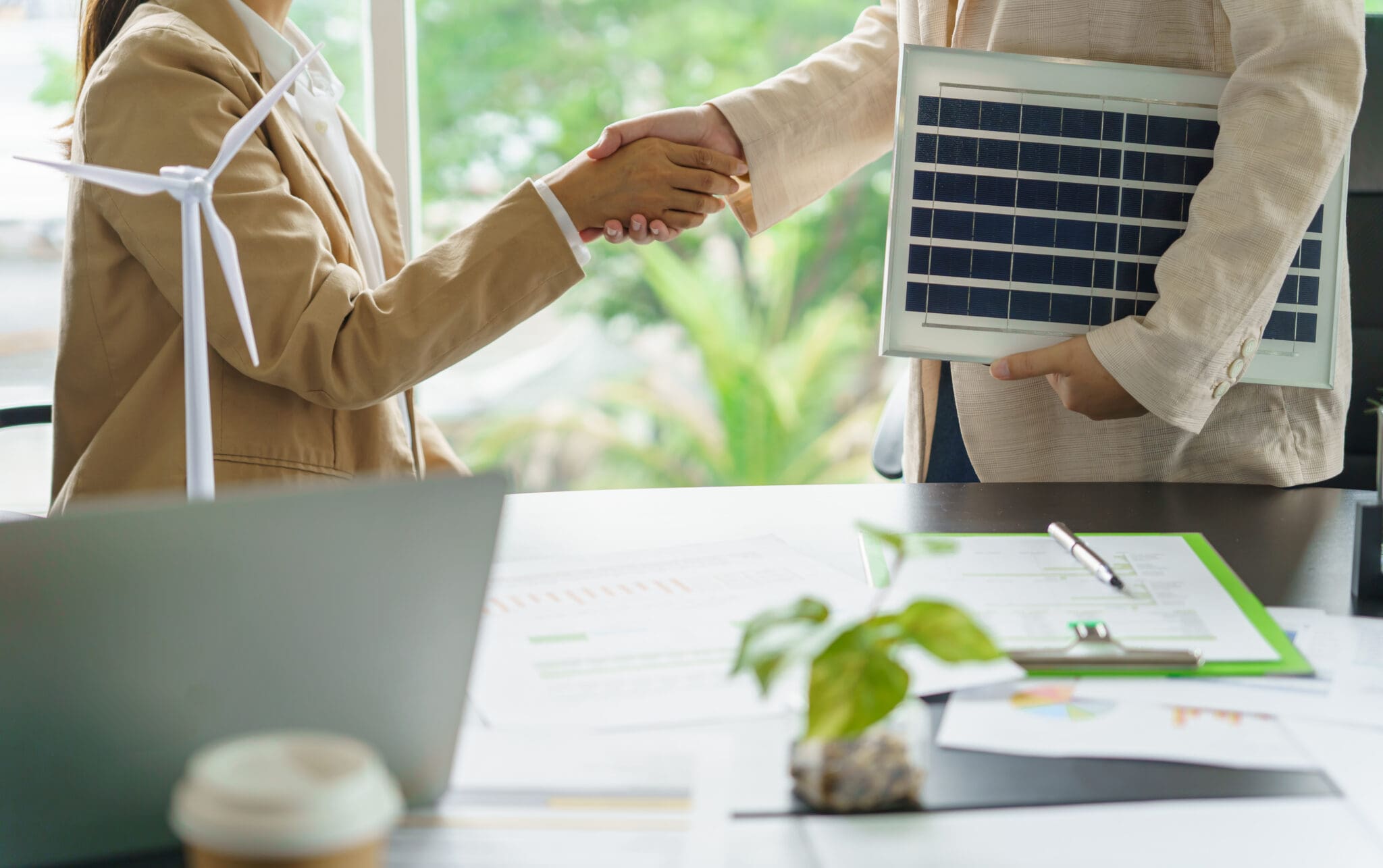 Handshake and business with solar panels green energy Business people working in green eco friendly office business meetingÂ creative ideas for business eco friendly.