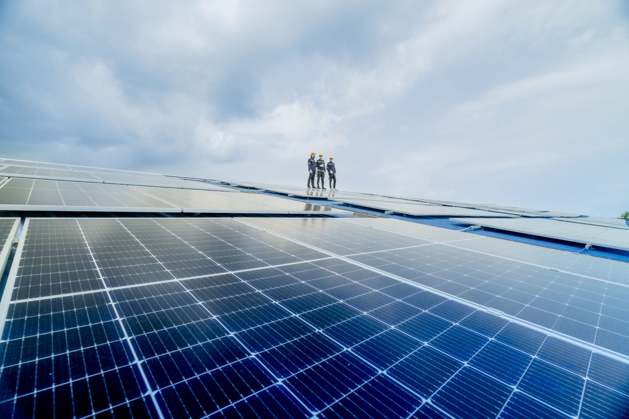 engineer man inspects construction of solar cell panel or photovoltaic cell by electronic device. Industrial Renewable energy of green power. factory worker working on tower roof.